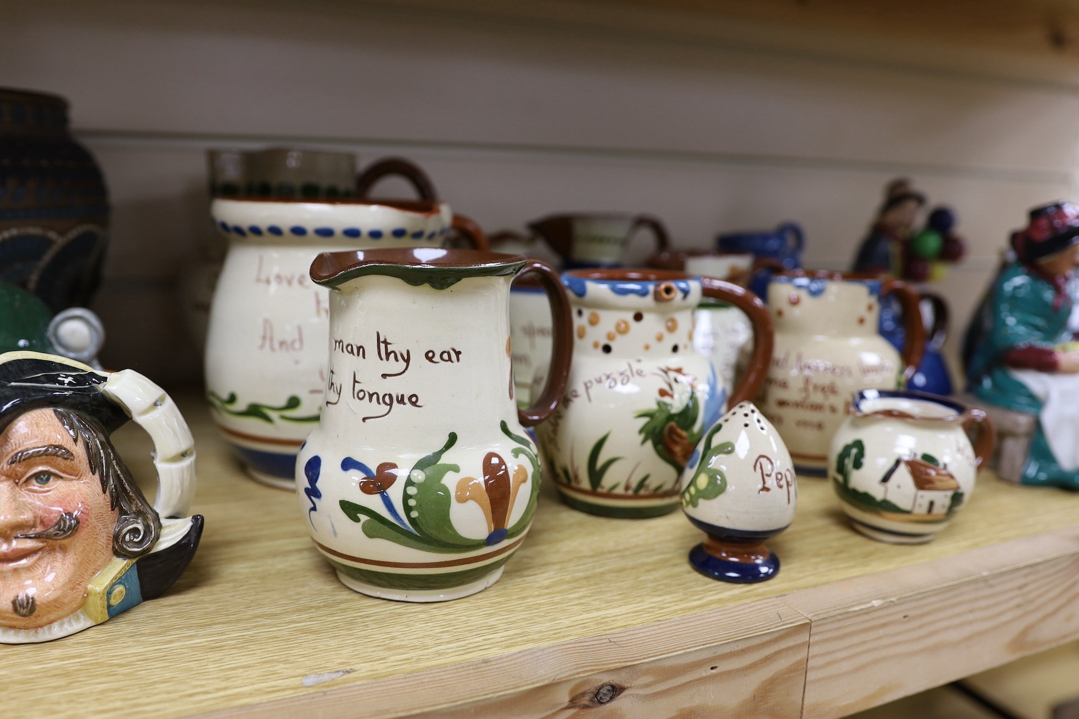 A collection of Doulton vessels and Torquay Mottoware